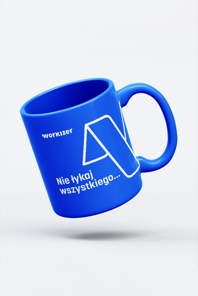 A blue coffee mug with a white geometric logo and the text, “Nie łykaj wszystkiego...” on the surface. The mug has a simple and modern design, with the text and logo prominently displayed. The mug is slightly tilted and appears to be floating against a soft white background.