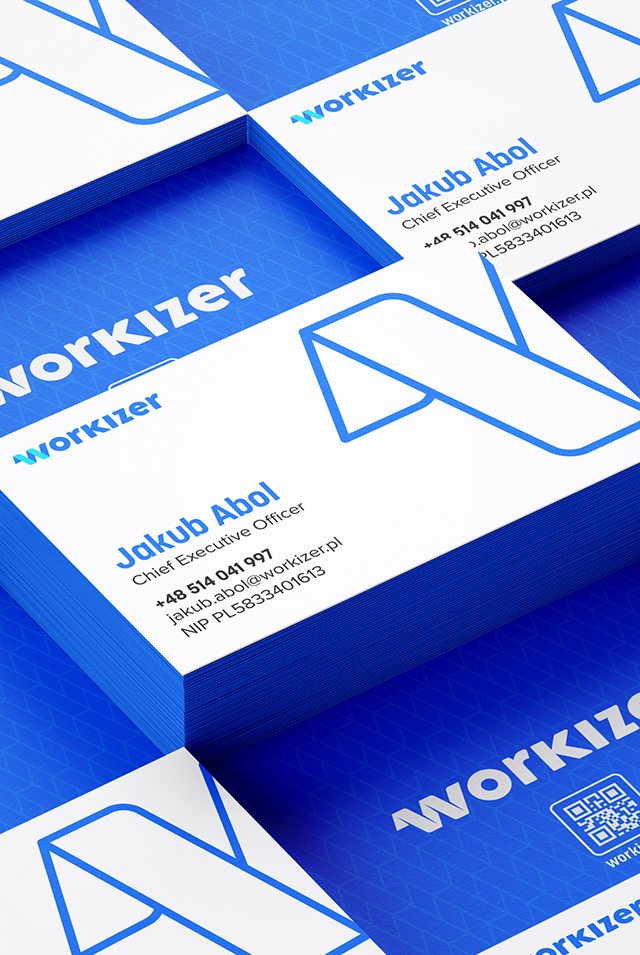 A stack of business cards featuring the "Workizer" logo prominently. The cards have a blue and white color scheme with geometric patterns. The name on the card is "Jakub Abol," and it includes contact details like phone number, email, and a QR code. The cards are neatly arranged and displayed on a blue surface.